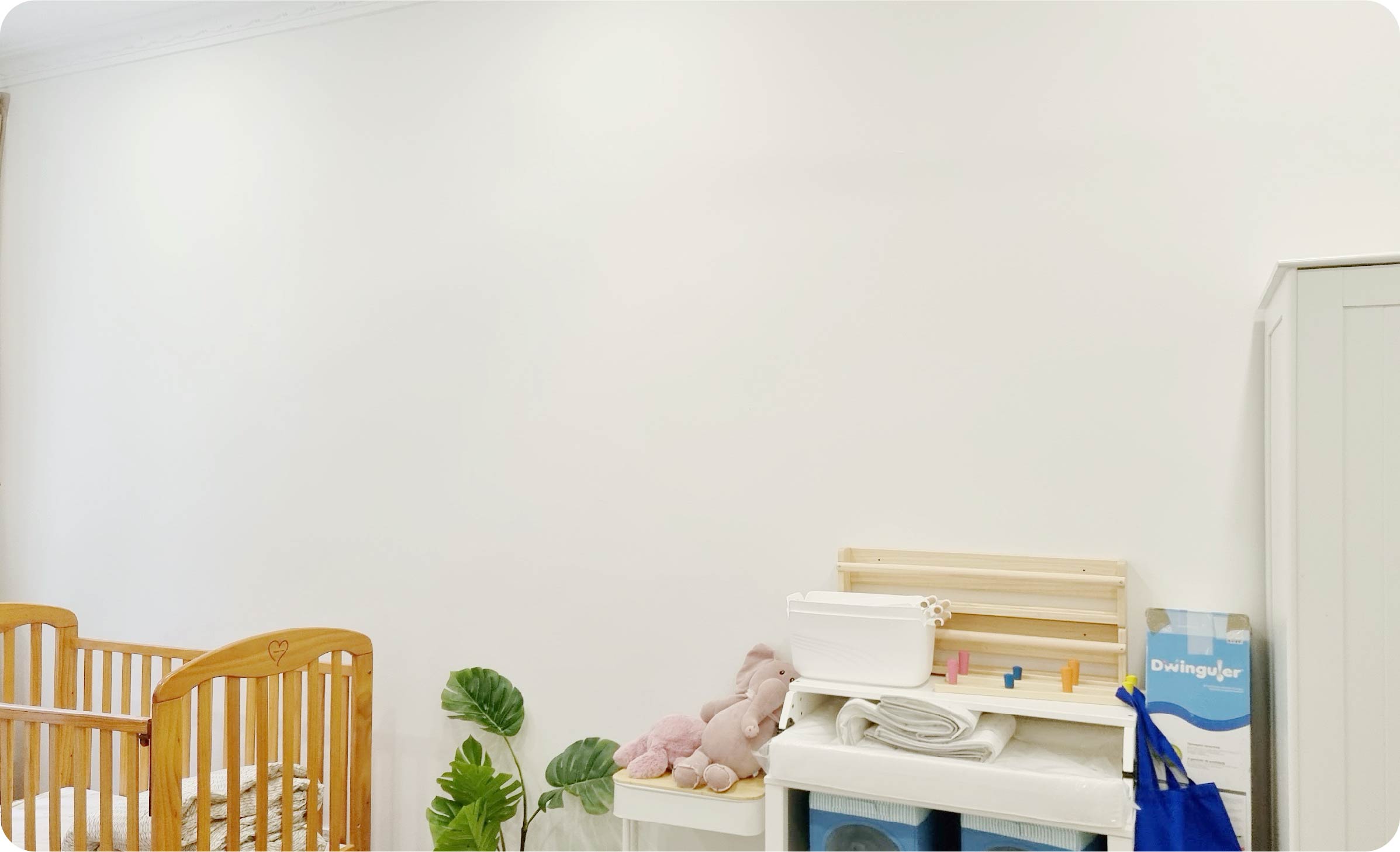 a kids room with a bland wall